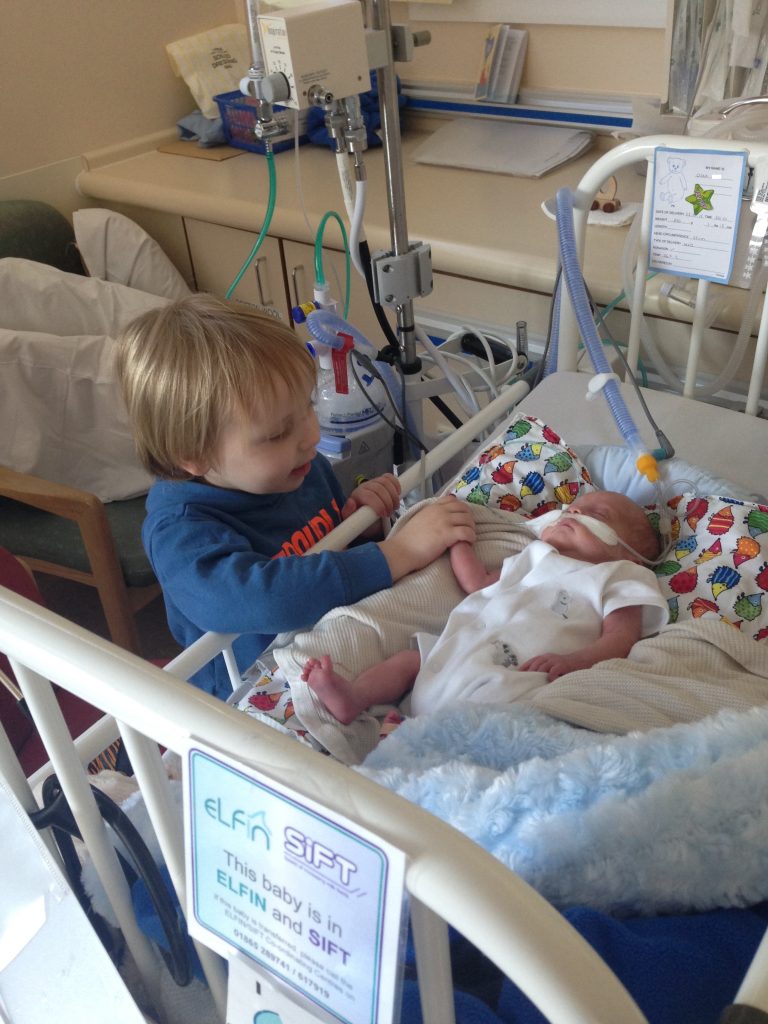 Oska at 3 months old in the neonatal unit with his big brother Dax