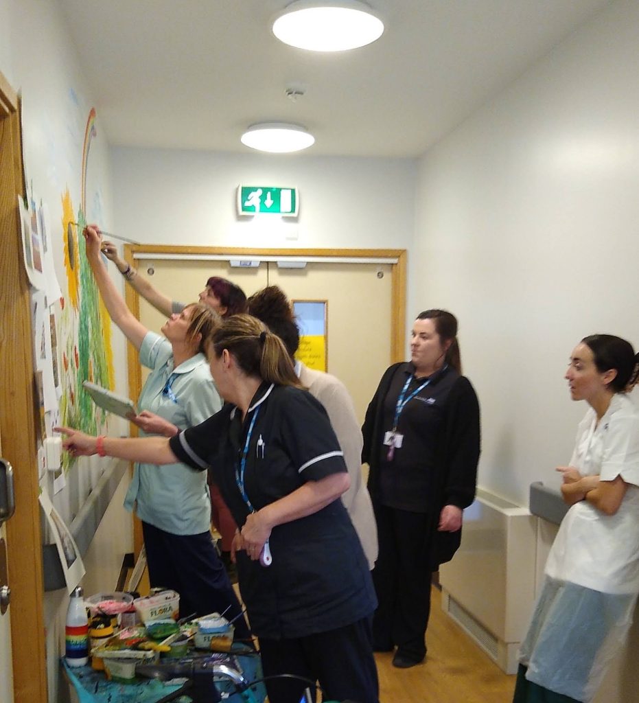 Staff paint a new mural at Lanchester Road Hospital
