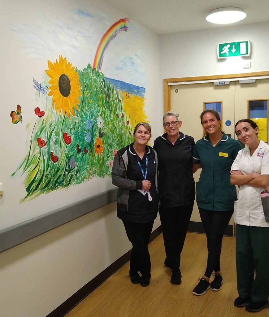 Hospital staff with one of the new murals