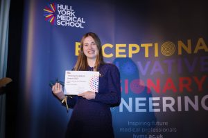 Polly Snelling with her award and certificate