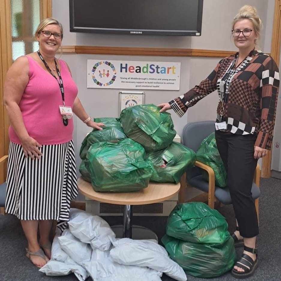 Sophie Antill (right) presents the uniforms to head Sarah Haylock.