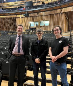 Dominic, centre, with staff from the theatre he is working in.