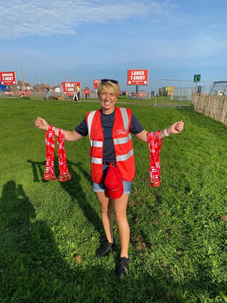 Janet Telford holding Tshirts