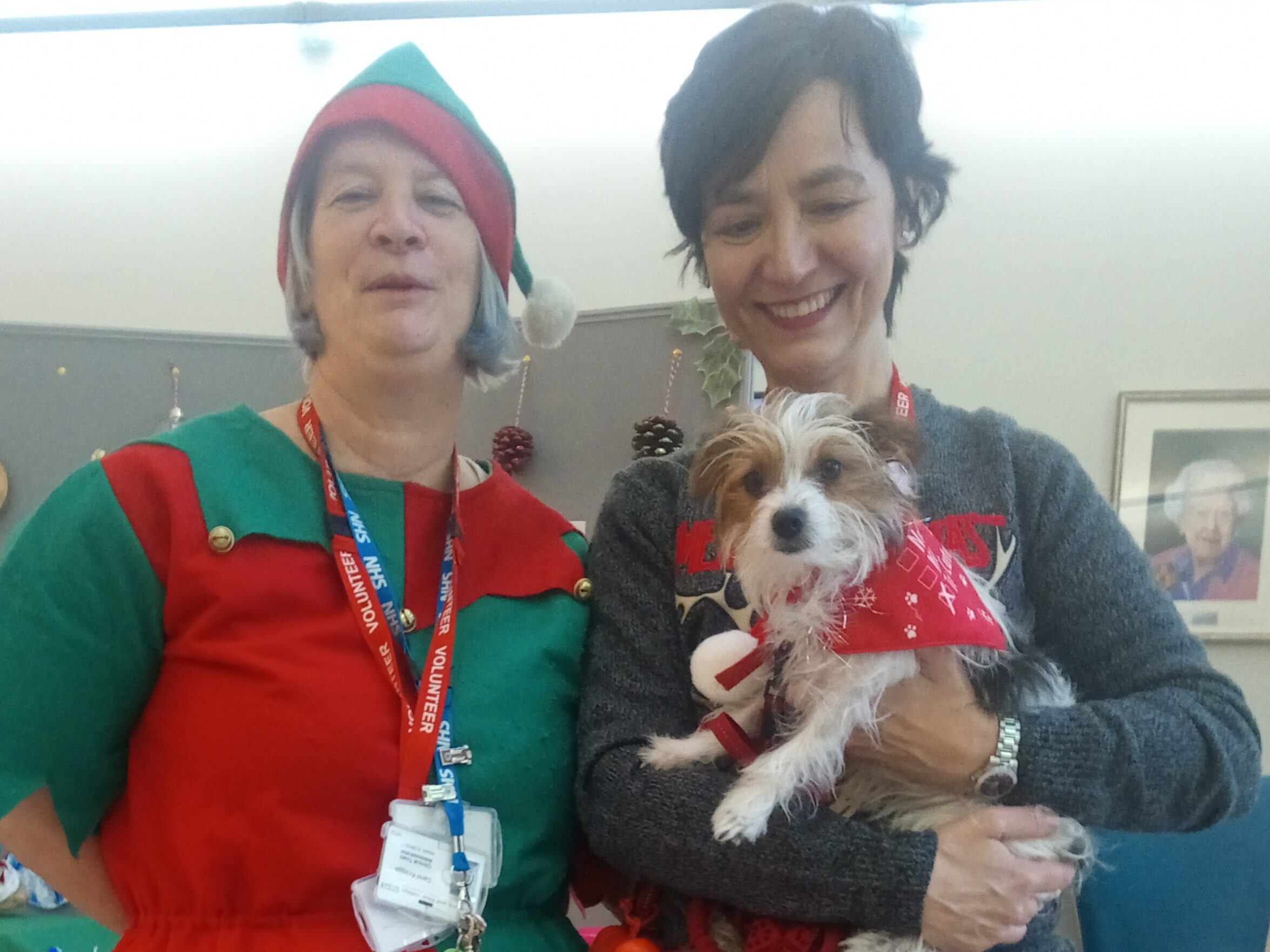 Carol Knaggs (left) and Yary Espinoza with Evie the therapy dog in front of the craft stall.