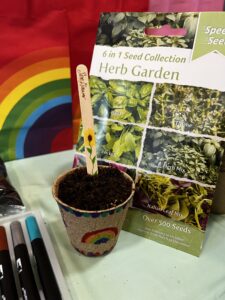 Planting seeds in a pot for Children's Mental Health Week