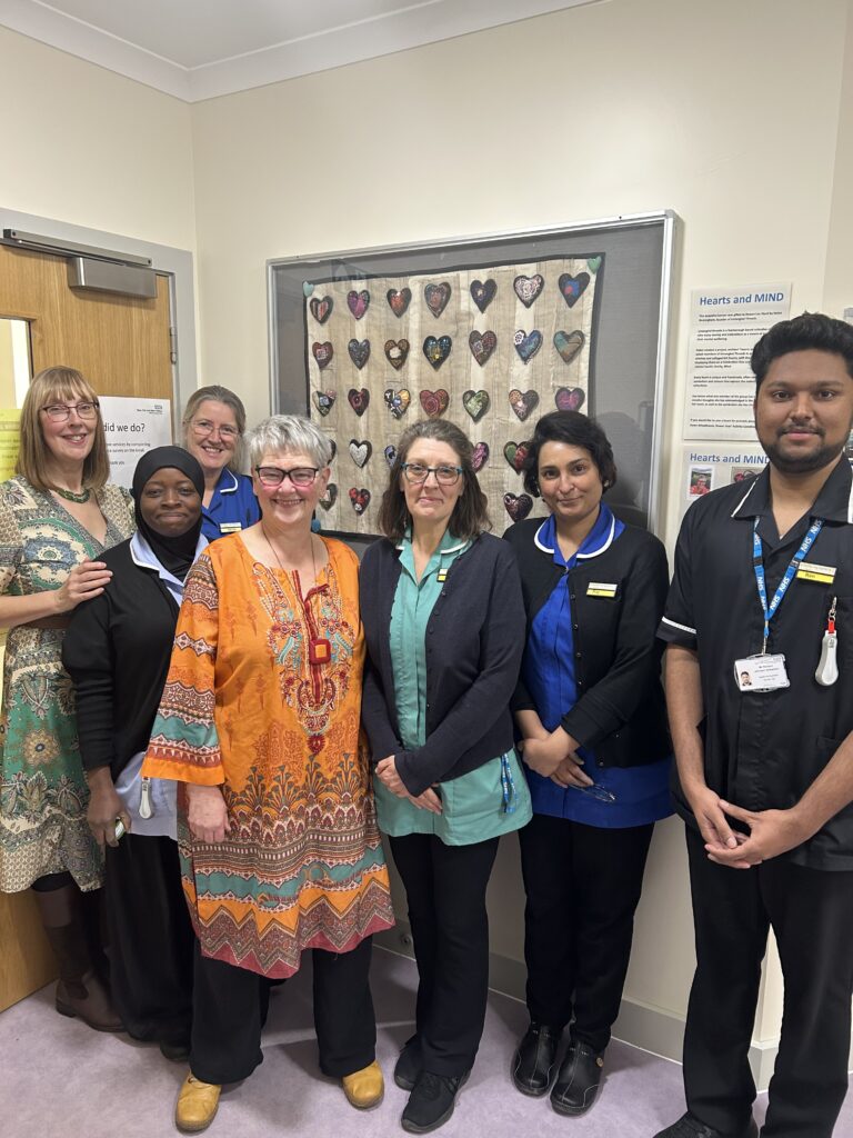 Dorothea Newham and Rowan Lea staff posing next to the display.