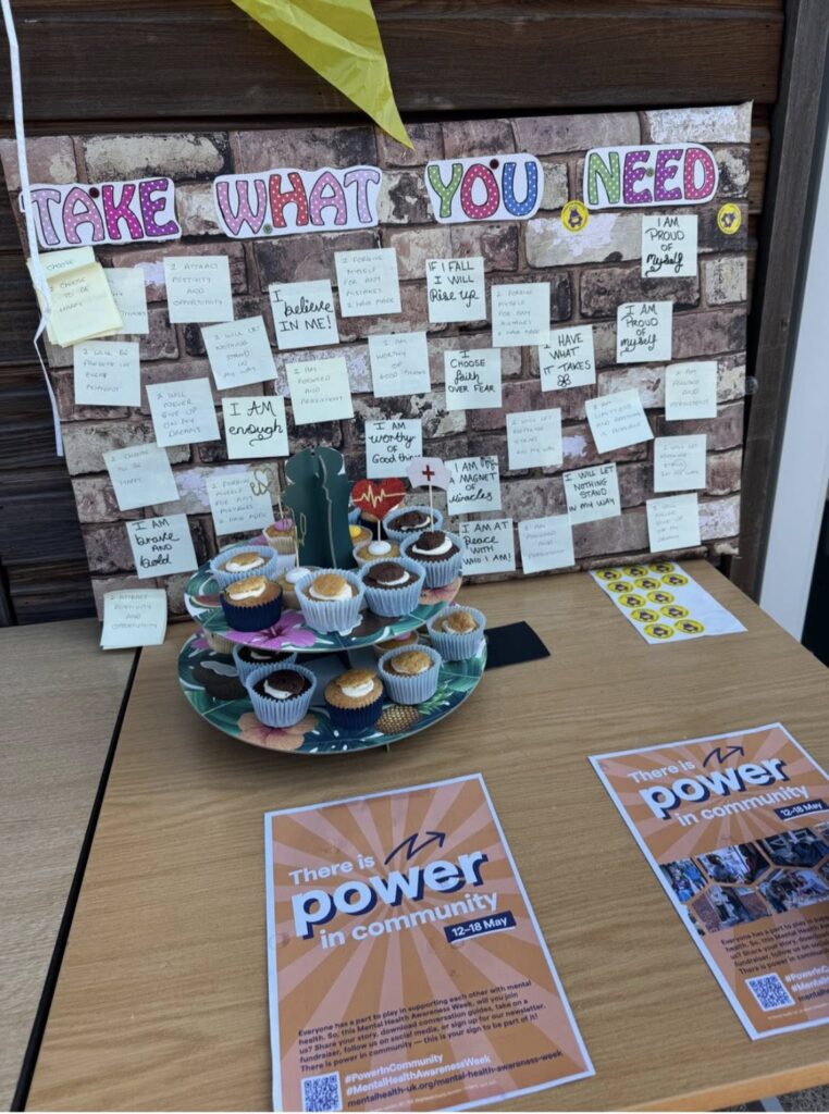 'Take what you need' affirmation board next to a cupcake stand