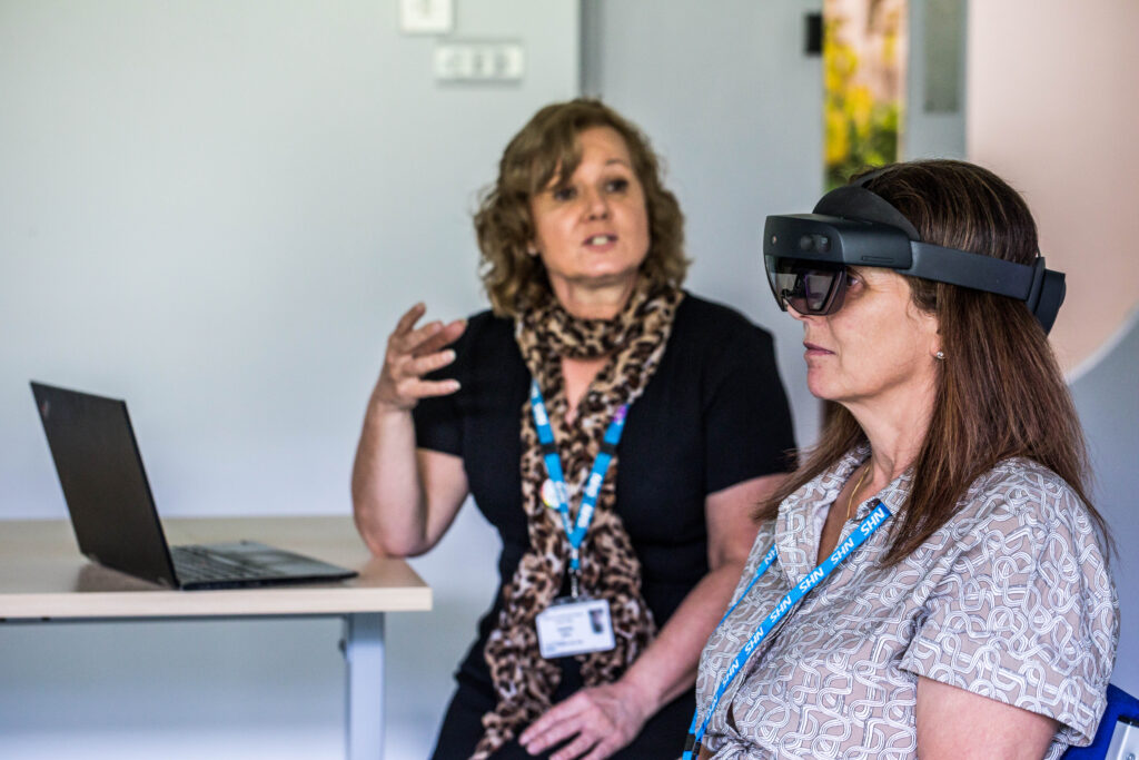 Jools Smithies, a senior nurse practice placement facilitator in our Trust, guiding a student through using the AR app and headset