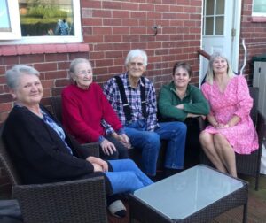 Sue and her parents and family in happier times.