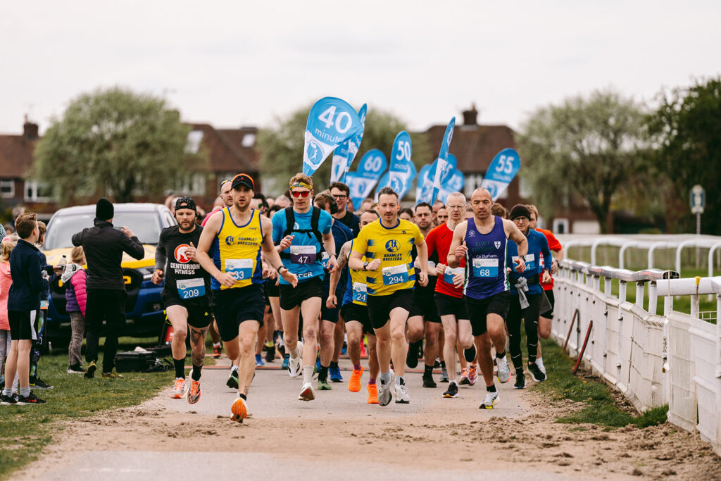 A photo of a group of people running the TEWV 10k in York.