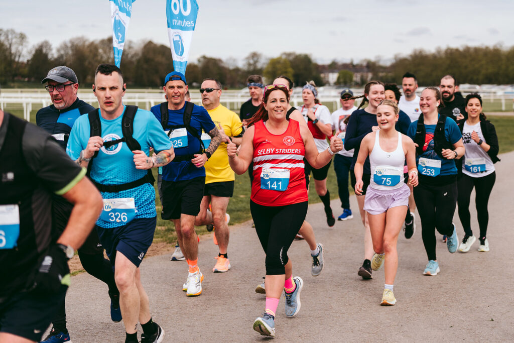 A photo of a group of people running the TEWV 10k in York.