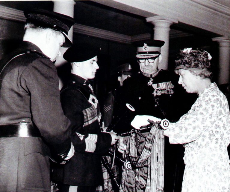 This photo was taken in 1961, when Bob was a Junior Pipe Major and presented to Royalty. Pictured left to right: Lt Col LHM Gregory, Bob Etherton with his pipes, Major General L de M Thullier and the then Princess Royal. (Princess Mary – the aunt of Queen Elizabeth II).