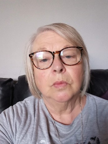 lady with bobbed blonde hair wearing glasses