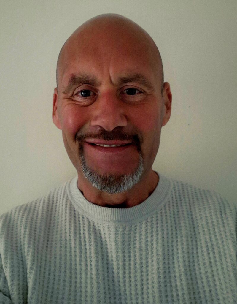 Man with bald head and beard smiling