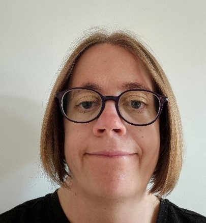 lady with blonde bobbed hair and glasses