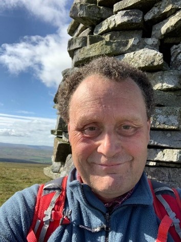 man with brown hair smiling