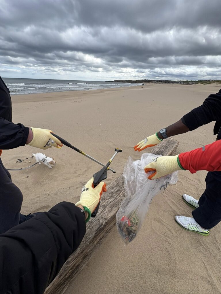 Our patients collecting litter and placing in a bag.