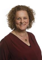 lady with blonde curly hair smiling