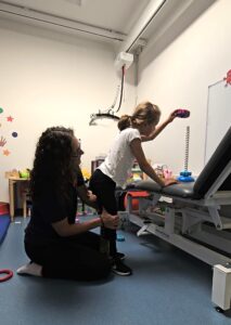 Paige undergoing physio to help her stand and walk.