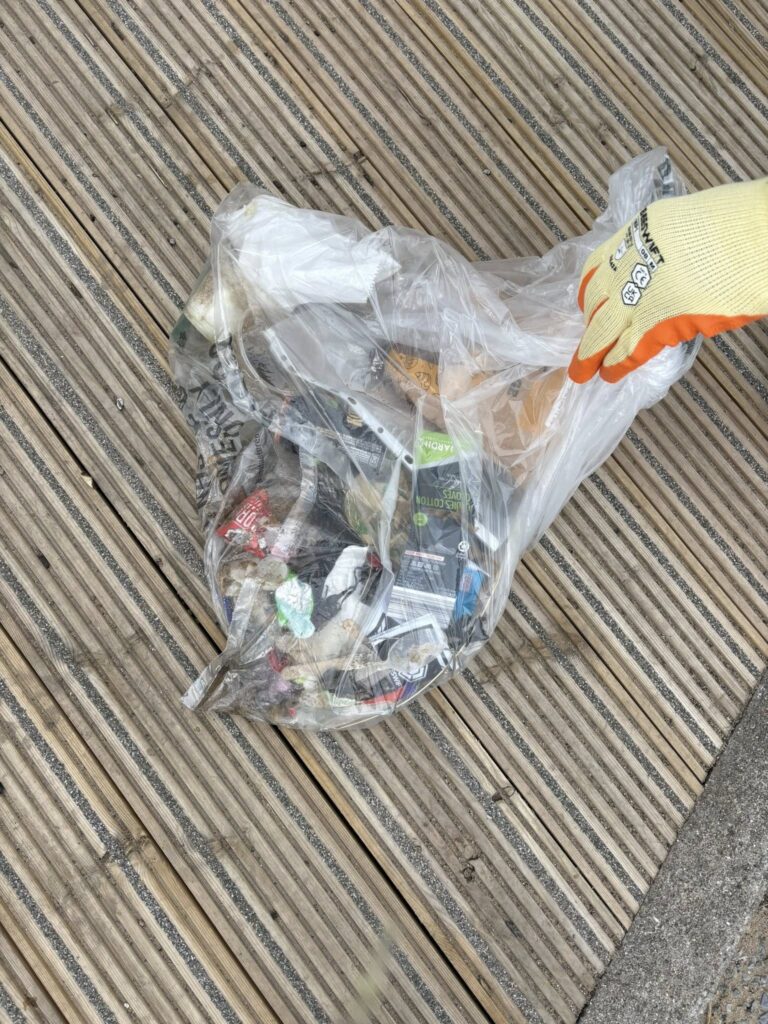 A bag full of litter that was collected from the beach