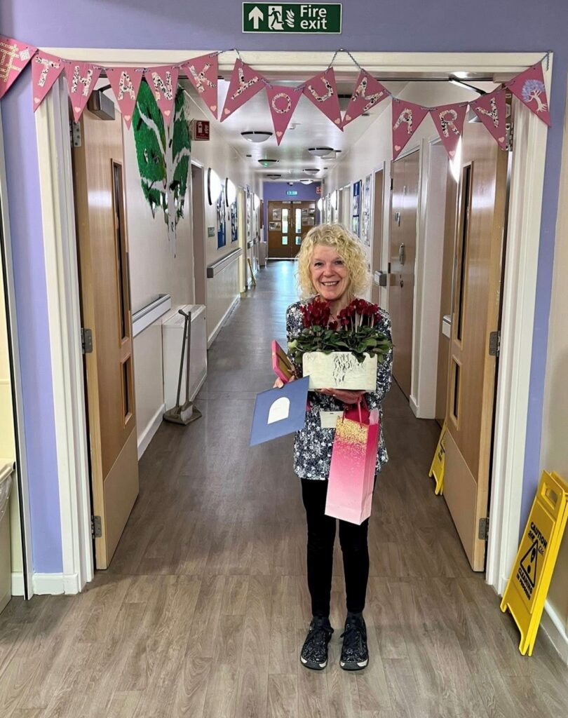 Mary with flowers and cards from Birch Ward patients and staff where she has been volunteering every week for 10 years.