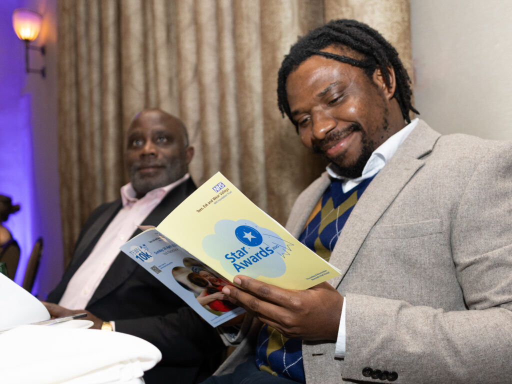 A Star Awards guest reading the programme