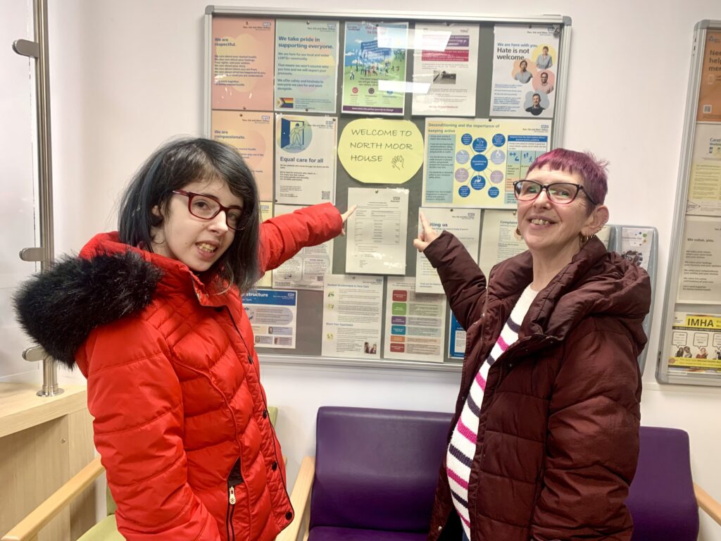 Involvement member Chloe (left) with Julianna in front of one of the revamped noticeboards.