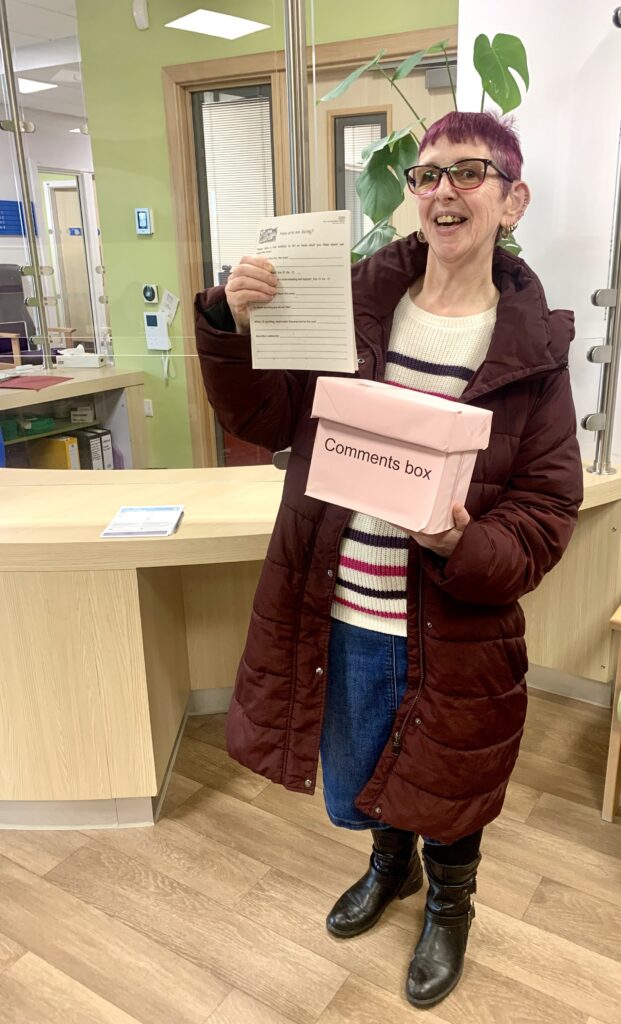 Julianna with the comments box which visitors can use to make suggestions for future improvements.