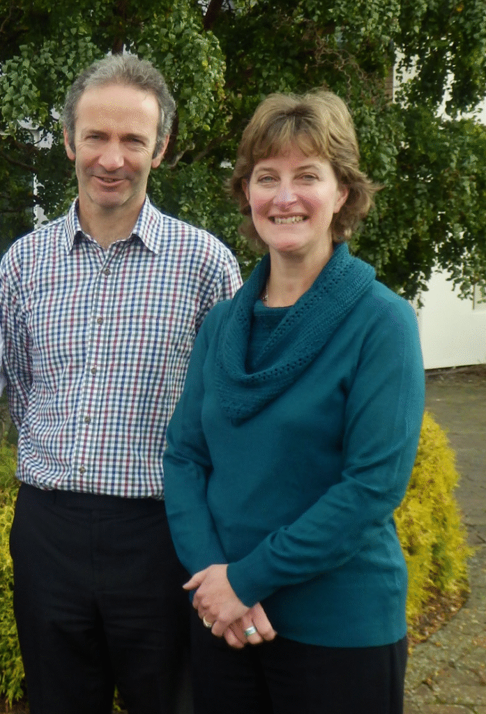 Paul Bernard, man in check shirt, stood with Jo Cromarty, lady in a teal jumper.