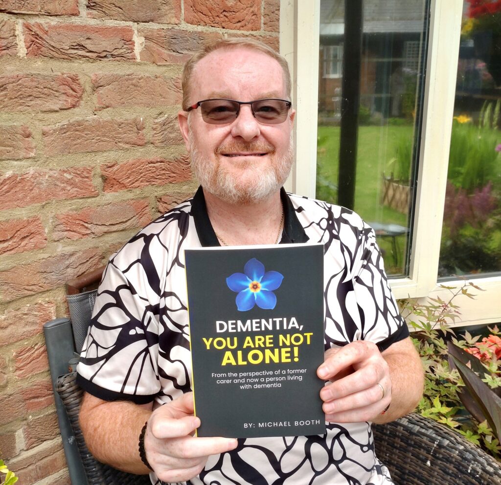 Michael with the factual book he wrote about dementia.