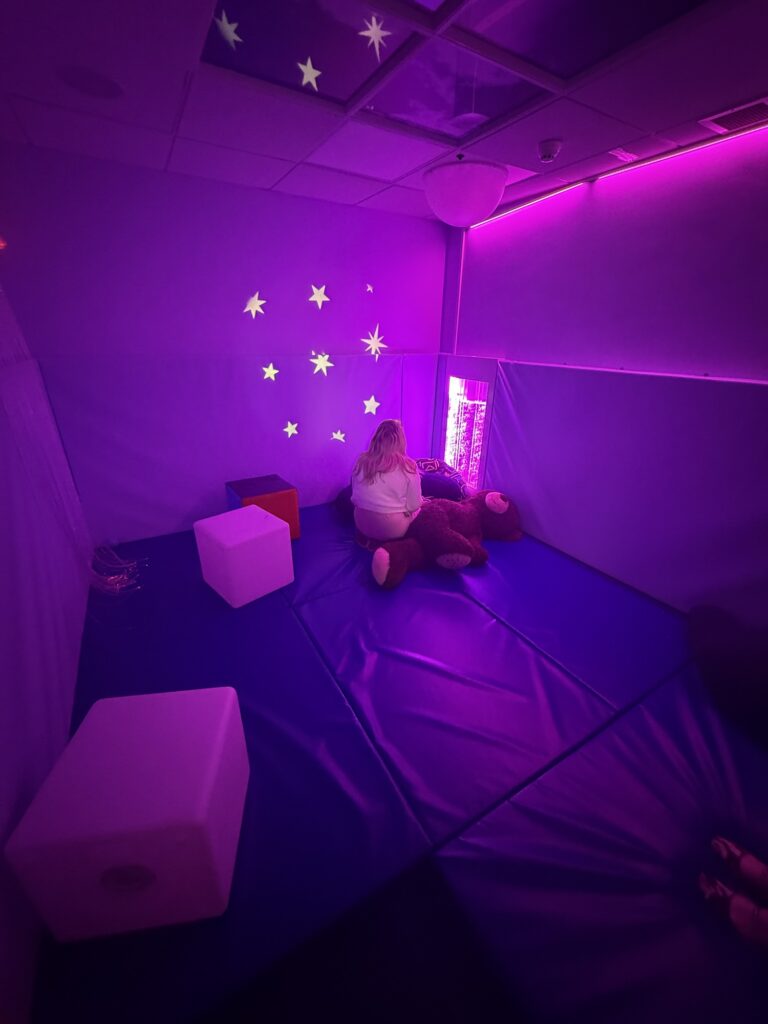 People using the Daisy Chain purple sensory room