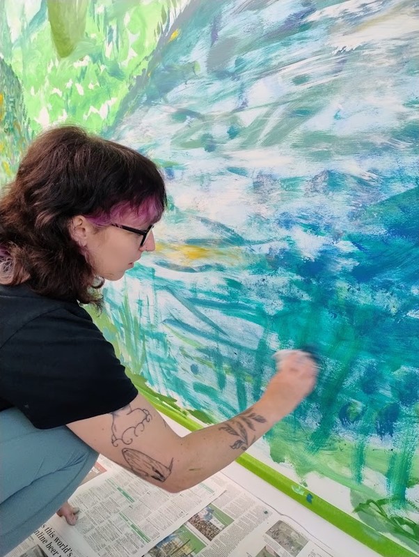 Becca creating part of the mural