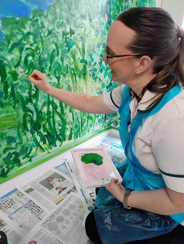 Devon helping to paint the mural