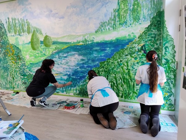 Staff painting mural at Foss Park