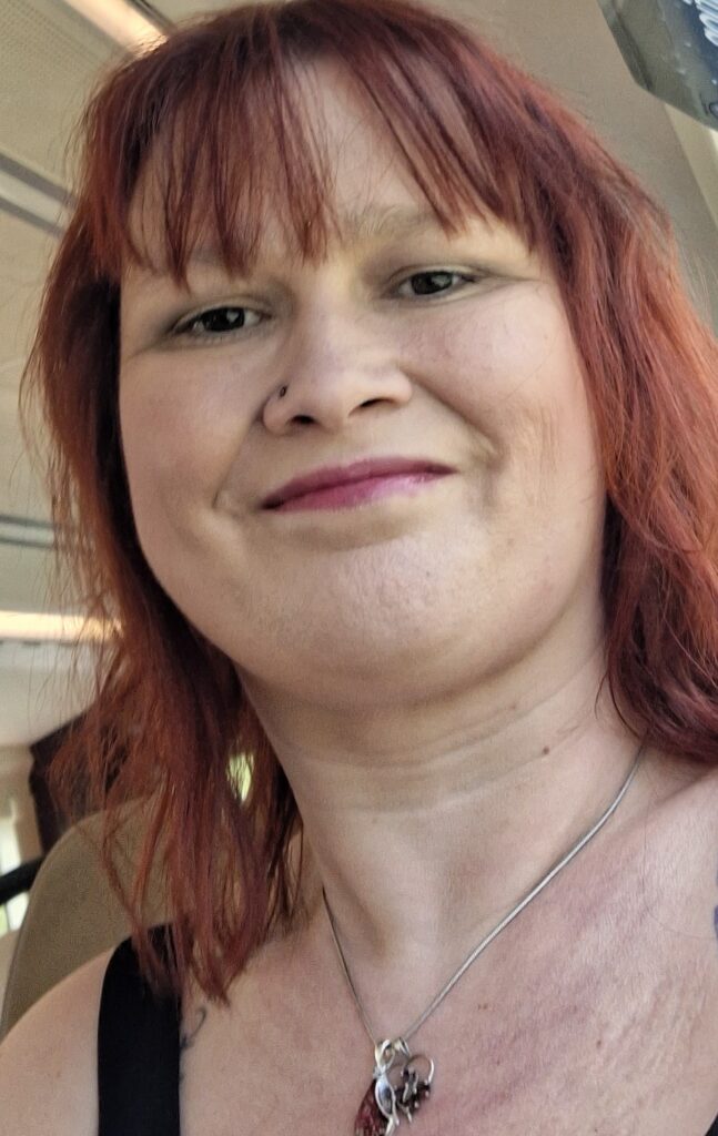 Lady smiling with red wavy hair
