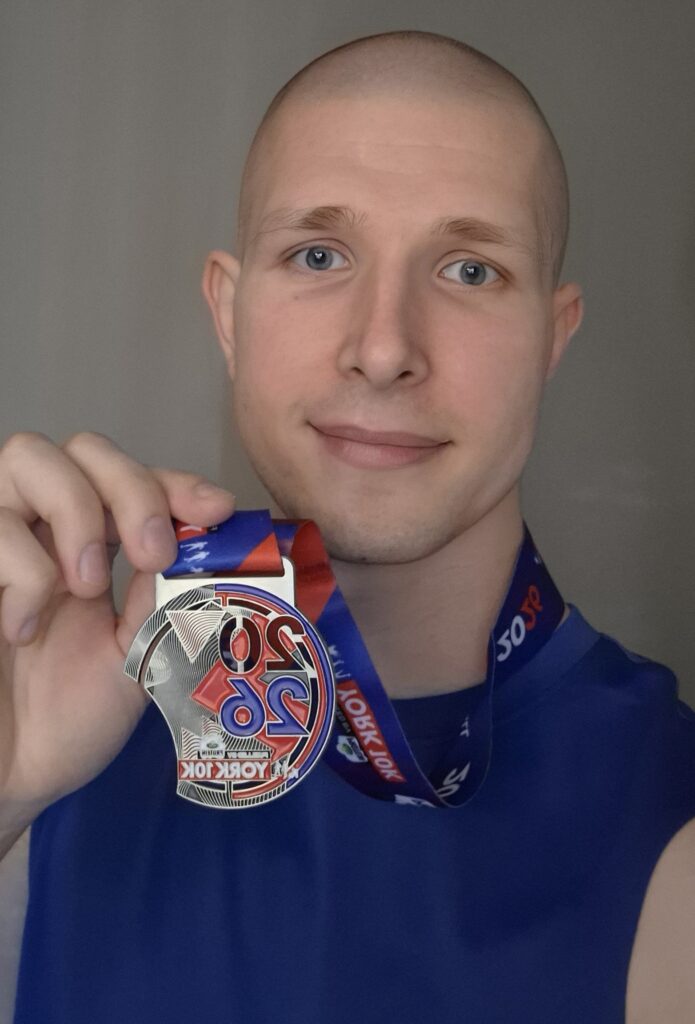 Piotr with his medal from the recent York run