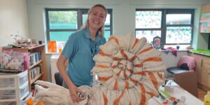 Staff member holding the large seashell