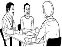 Three people chatting around a table