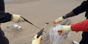 Our patients collecting litter and placing in a bag.