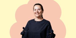 lady with black top and dark hair tied back in a ponytail