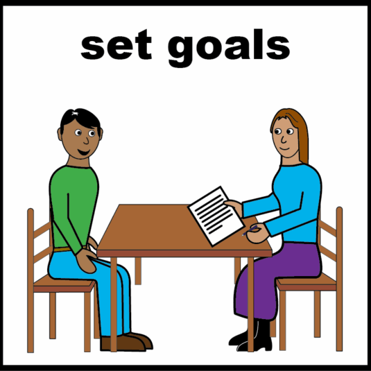 two people talking at a table with a piece of paper