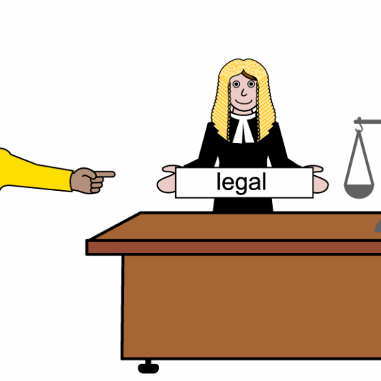 person pointing to a judge sitting behind a desk with scales and the word legal