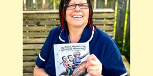 Trust nurse Julia with her book about dementia.