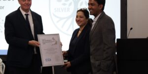 Colleagues being presented with the Silver Award certificate